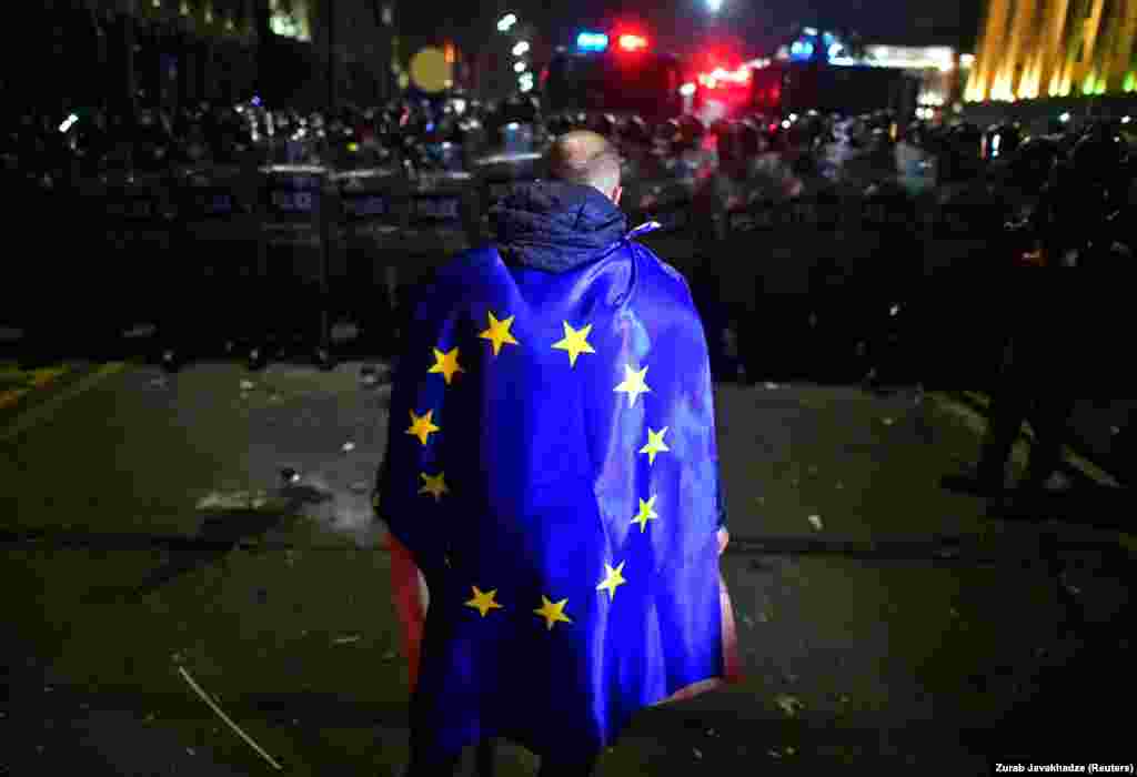 A demonstrator wears a European Union flag during the aforementioned Georgian protests against a draft law on &quot;foreign agents,&quot; which critics say represents an authoritarian shift and could hurt Georgia&#39;s bid to join the European Union, in Tbilisi on March 9. On March 10, Georgian lawmakers voted to drop the bill.