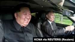 Russian President Vladimir Putin (right) and North Korean leader Kim Jong Un enjoy a ride together in a Russian armored limousine during Putin's visit to Pyongyang last week. 