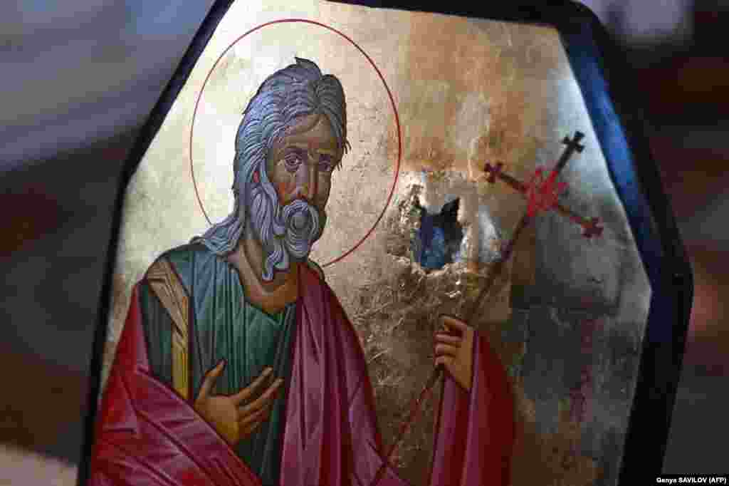 An Orthodox icon drawn on an armored plate with a bullet hole is displayed at a consecration ceremony at St. Michael&#39;s Golden-Domed Cathedral in Kyiv on May 23.