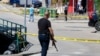 A Bosnian policeman attends a crime scene following a brutal triple homicide that was live streamed on social media on August 11. 