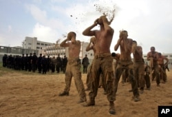 Regruti Hamasovih snaga sigurnosti bacaju pijesak na svoja lica dok učestvuju u vježbi obuke u kompleksu u gradu Gaza, utorak, 13. marta 2007.