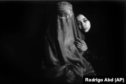 Hakimeh, 55, and her daughter, Freshta, 16, pose for a portrait on May 29 in the Kabul carpet factory where they have been working for a year. Hakimeh once worked in the homes of the wealthy. Freshta was once a student until her dreams were dashed by the Taliban. They both work to support their family.