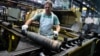 An employee handles 155 mm shells after the manufacturing process at the Scranton Army Ammunition Plant on April 16.