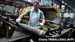 An employee handles 155 mm shells after the manufacturing process at the Scranton Army Ammunition Plant on April 16.