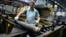 An employee handles 155 mm shells after the manufacturing process at the Scranton Army Ammunition Plant on April 16.