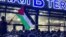 A local man waves a Palestinian flag with a message reading "Daghestan Stands By You" during a pro-Palestinian rally at Makhachkala airport after the arrival of a scheduled flight from Tel Aviv on October 29.