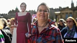 Učesnica protesta "Neka žene govore" nosi kartonsku figuru spisateljice JK Rowling koja je kritikovala novi škotski Zakon protiv zločina iz mržnje, Edinburg 6. april 2024. 