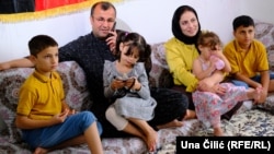 Afghan Seema Stanikzai sits with her husband, Jan Mohammad Habibi, and their four children in their new home in Nuremberg, Germany.