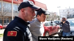 Do Kwon is escorted to a court in Podgorica on March 24.