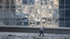 A man walks through debris next to a damaged office building in Moscow following a drone attack on August 1.
