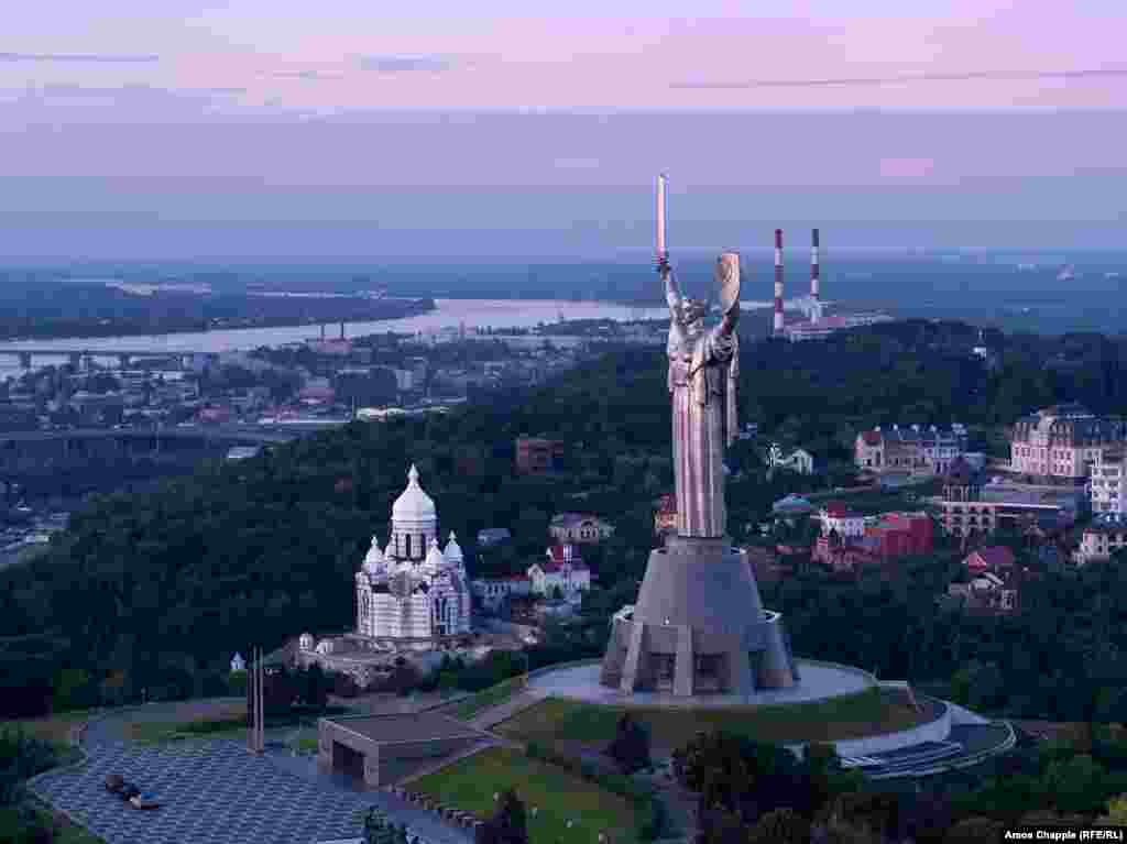 The Motherland Monument is a 102-meter-high statue commemorating Soviet victory in World War II. The steel figure looks east from the right bank of the Dnieper River in Kyiv.&nbsp;
