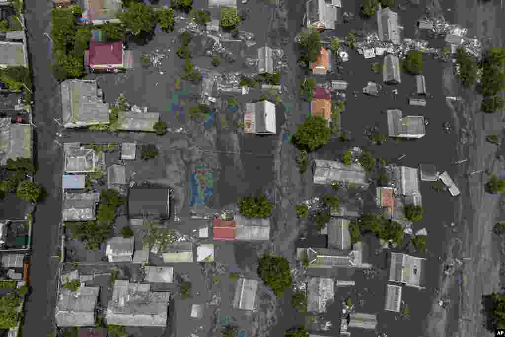 The colors of an oil slick stand in stark contrast to the muddy floodwaters in a neighborhood in Kherson on June 10. &nbsp;