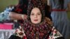 A young bride poses during preparations for her wedding with a traditional wedding costume in the village of Bixad, Romania.