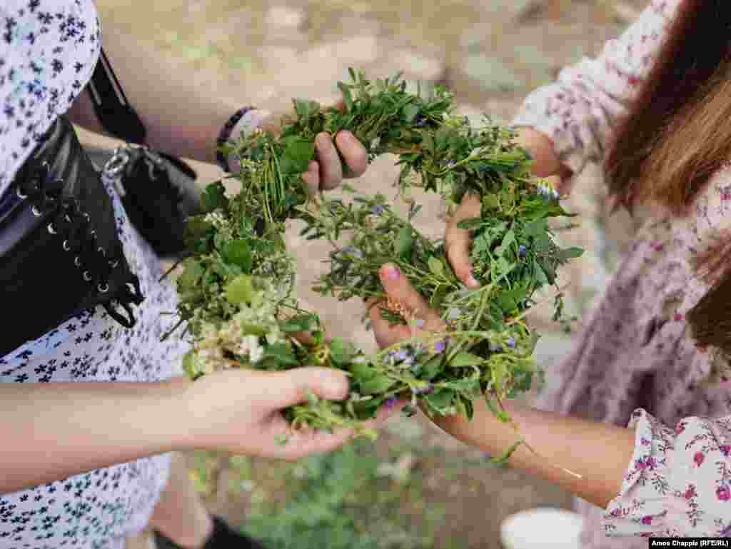 Girls prepare a wreath of greenery foraged from Prague&rsquo;s riverbank. Ivan Kupala is an eastern Slavic tradition that predates Christianity and involves rituals, including the weaving of wreaths that are later cast into a river, and the burning, or &quot;drowning&quot; of effigies. &nbsp;