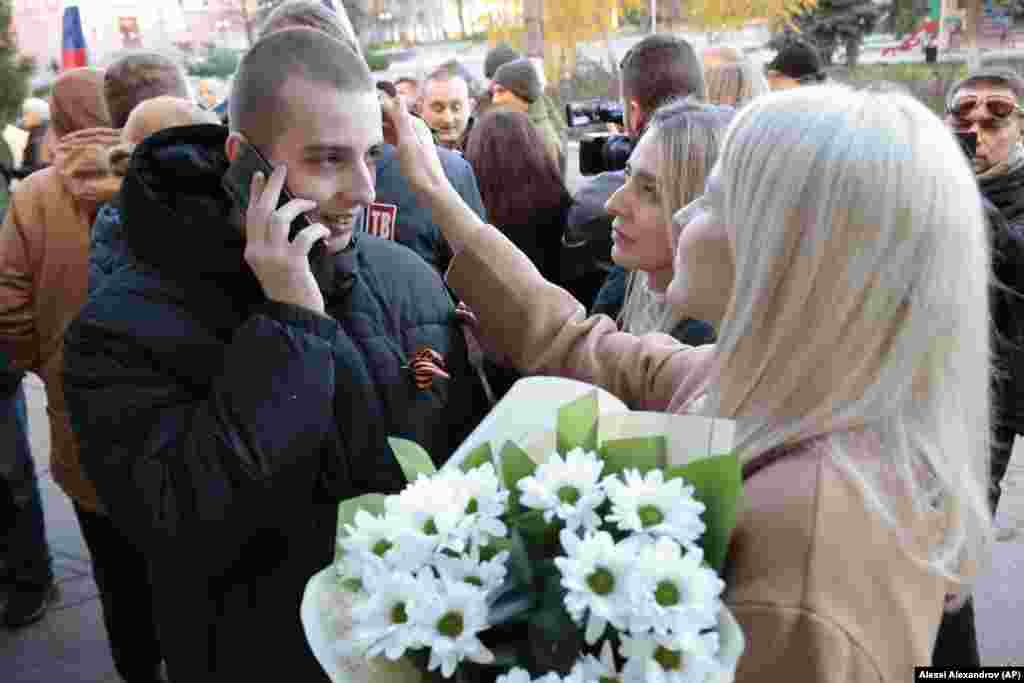 Friends of a freed pro-Russian soldier greet him in Amvrosiyivka, in the Russian-held area of the Donetsk region, on November 1, 2022.&nbsp; &nbsp;