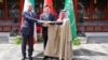 Iranian Foreign Minister Hossein Amir-Abdollahian (left), Saudi Arabian Foreign Minister Prince Faisal bin Farhan Al Saud (right), and Chinese Foreign Minister Qin Gang shake hands during a meeting in Beijing on April 6. 