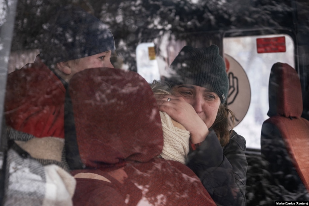 Iryna holds her mother's body after her sudden death.