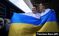 Ukrainian singers Jerry Heil (left) and Alyona Alyona before leaving for Eurovision 2024 at the main railway station in Kyiv on April 25