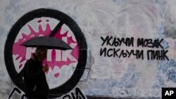PINK nije proruska TV stanica, kažu u odgovoru iz tog medija. Fotografija: Čovek prolazi pored grafita sa prekriženim logom Pinka i natpisom "Uključi mozak, isključi Pink", Beograd, maj 2023.