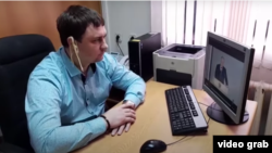 Russian regional lawmaker Mikhail Abdalkin listens to Vladimir Putin's speech on February 21 with noodles on his ears. 