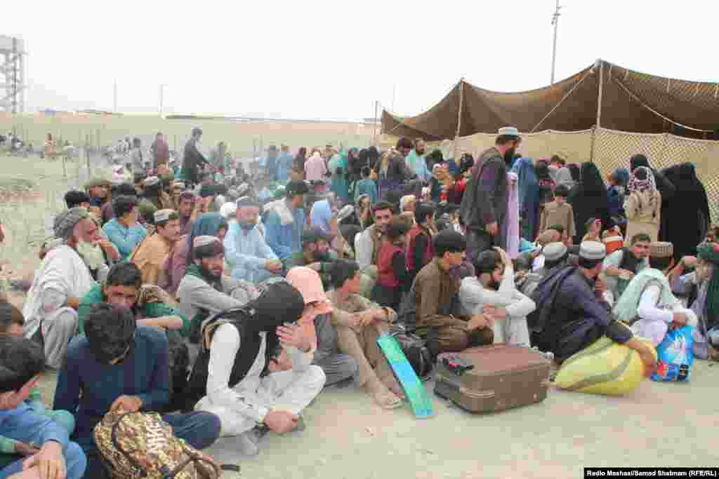 Afghan men and boys sit patiently at the holding center. Major roads leading to the border crossings were jammed with trucks carrying families and whatever belongings they could carry.