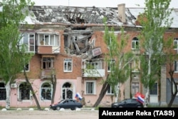 Cars fly tsarist, Soviet, and Russian flags in Syevyerodonetsk, in Ukraine's Luhansk region in May 2023.