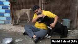 <div>Iranian cleric Sayed Mahdi Tabatabaei cuddles an impaired dog at his shelter outside the city of Qom, 125 kilometers south of the capital, Tehran, on May 21. Tabatabaei has amassed over 80,000&nbsp;<a href="https://www.instagram.com/sayedmahditabatabaei/?igshid=MzRlODBiNWFlZA%3D%3D">followers</a>&nbsp;on Instagram as he shares his heartbreaking stories of the abused and neglected dogs that he has treated at his shelter.&nbsp;&nbsp;</div>

