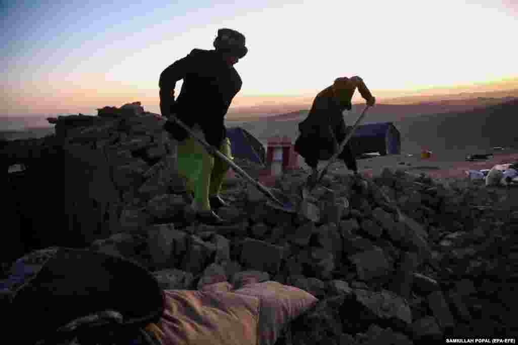 Men search for belongings to salvage as the day turns to night. The U.S. Geological Survey&nbsp;recorded&nbsp;the largest of the earthquakes at a magnitude of 6.3, with the latest aftershock coming about 30 kilometers northeast of the city of Zindah Jan, which has a population of about 70,000 people.