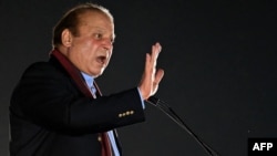 Pakistani ex-Prime Minister Nawaz Sharif addresses supporters during an event held to welcome him in Lahore in October 2023.