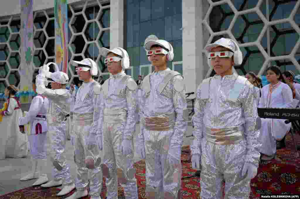 Children wait for the arrival of Turkmen President Serdar Berdymukhamedov prior to the opening of a children&#39;s medical center as part of events inaugurating the new city of Arkadag -- named in honor of Turkmenistan&#39;s former leader, Gurbanguly Berdymukhammedov -- some 30 kilometers outside the capital, Ashgabat.&nbsp;