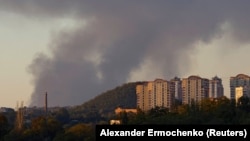 Smoke rises from the area in the direction of Avdiyivka as seen from Russian-occupied Donetsk.