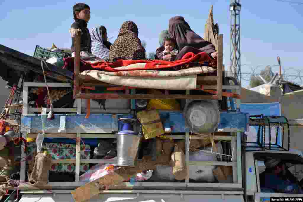 Afghan refugees with their belongings arrive on vehicles from Pakistan at a registration center near the Afghanistan-Pakistan border in Kandahar Province.&nbsp;