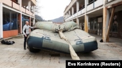 A worker prepares an inflatable decoy of a military vehicle during a media presentation in Decin, Czech Republic, on March 6.