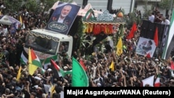 Iranians attend the funeral procession of Ismail Haniyeh in Tehran on August 1. 