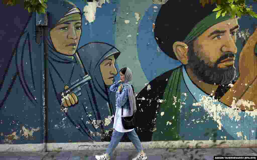 &nbsp;An Iranian woman walks past a mural on Palestine Square in Tehran.&nbsp;