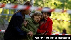 A woman reacts as she looks at the body of her daughter, who was killed during a Russian missile strike in Kyiv on June 1.