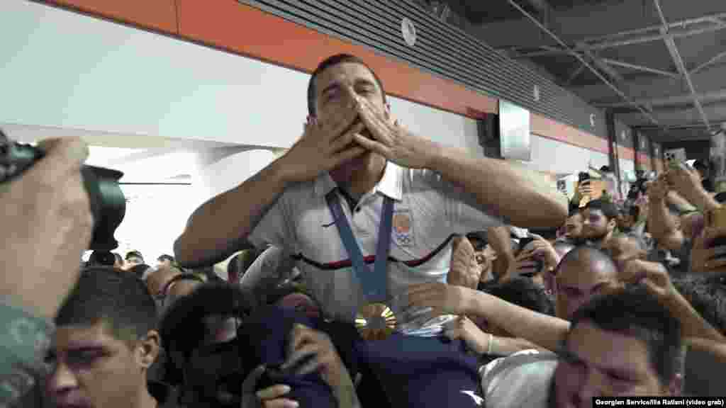 Lasha Bekauri of Georgia gets a hero&#39;s welcome as he and his judo teammates arrive at Tbilisi airport on August 4. The Georgian judo team won one gold and two silver medals at the Paris Olympics, with Bekauri earning a second Olympic gold.