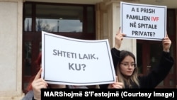 With signs reading "Secular state, where?" and "Does IVF in private hospitals destroy a family?," a group of activists protests in front of the Kosovo national assembly on February 29 against deputies who are dragging their feet over a draft bill that would grant women access to in vitro fertilization treatment. 