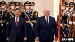Belarusian autocrat Alyaksandr Lukashenka walks with Chinese leader Xi Jinping in the Great Hall of the People in Beijing on March 1.