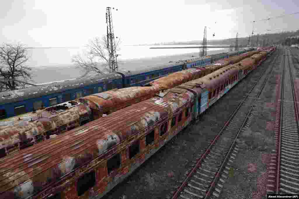 Ova fotografija izgorelih železničkih vagona na glavnoj plaži u Mariupolju i delimično zaleđenog Azovskog mora snimljena je 25. februara 2023.