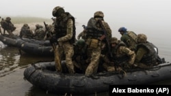 UKRAINE – A group of Ukrainian marines sail from the riverbank of Dnipro at the frontline near Kherson, October 14, 2023