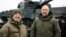 Ukrainian Prime Minister Denys Shmyhal (right) and Defense Minister Oleksiy Reznikov stand next to the first Leopard 2 tanks delivered from Poland on February 24.