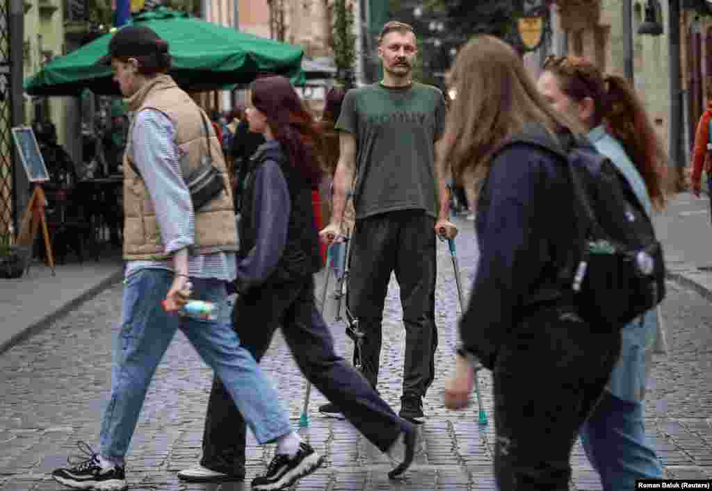 Oleksandr Yabchanka stands among the crowds in Lviv on October 1. The 42-year-old pediatrician and former Health Ministry adviser is concerned that Ukrainians may be burying their heads in the sand over the war with Russia. &quot;Guys, sooner or later (the war) will catch up with you,&quot; said Yabchanka, who was back home in western Ukraine waiting for his wounded leg to heal before returning to his unit.