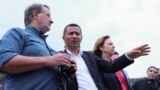 (Left to right) U.S. Senator Gary Peters (Democrat-Michigan), Syunik Governor Robert Ghukasian, and U.S. Ambassador to Armenia Kristina Kvien look out from the Armenian side of the border near the town of Kornidzor on September 23.
