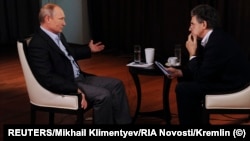 Russian President Vladimir Putin (left) speaks to Hubert Seipel during an interview for the German channel ARD in Vladivostok, Russia, on November 13, 2014. 