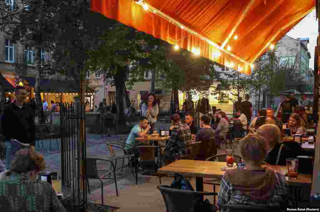 People enjoy a summer night at outdoor cafes in Lviv, where a common topic of discussion revolves around their personal plans &quot;after the victory.&quot; &nbsp;