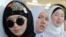 Kyrgyz women hijab look on as they take part in celebrations for World Hijab Day in Bishkek.  Kyrgyzstan is the only Central Asian country that has not officially banned the hijab, although the issue is a matter of debate there. (file photo) 