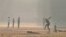 Youths play cricket amid smoggy conditions in Lahore on November 14. 
