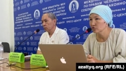 Members of the unregistered Naghyz Atazhurt party Turarbek Asylbekov (left) and Nazigul Maqsutkhan attend a press conference in Almaty on August 7.