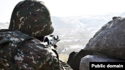 An Armenian soldier at a combat position near the border with Azerbaijan (file photo)